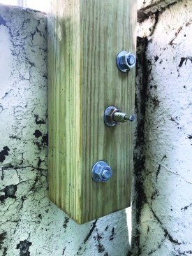 Post attached with epoxied bolts and a hammer-drive anchor
