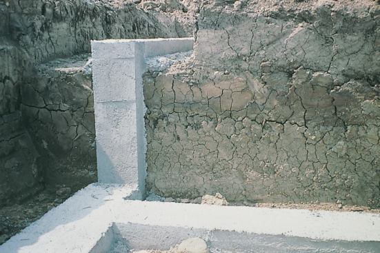 Stepped footings are used at changes in elevation in masonry foundations, but may not be necessary for poured concrete foundations.