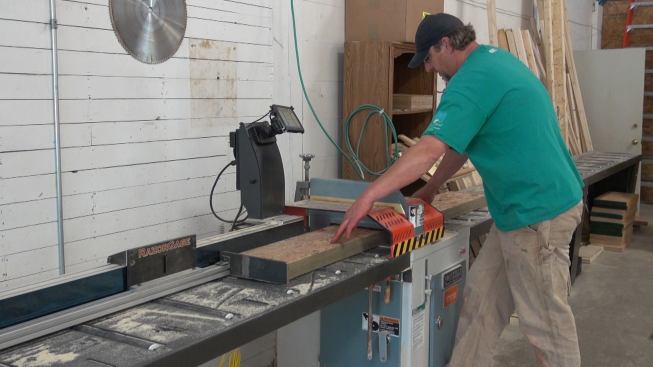 Steve Greenleaf cuts engineered rim board to length for a window buck, using EcoCor’s Northtech 18-inch up-cut cutoff saw. Equipped with a digitally controlled RazorGage positioning system, the Northtech saw is used for fast precision cutting of all the lumber components of the Passive House walls, including studs, wood I-joists, engineered headers, and strapping.