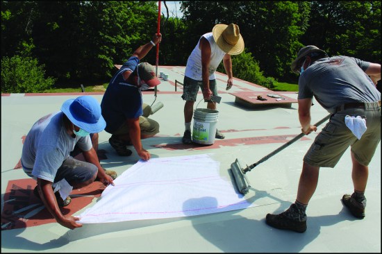 NDC crew members apply Acrylabs fluid-applied roofing to a 30-square roof located in New Yorkās Hudson River Valley.