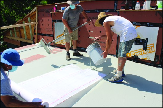 Workers bedded fabric in the coating.