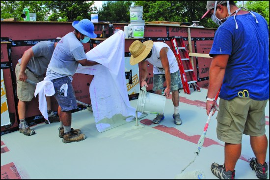 ā¦taking care to smooth out wrinkles in the fabric as they squeegeed the coating to the desired 25-mil thickness.