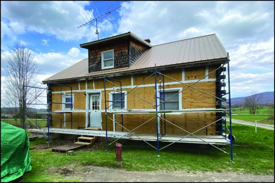 Built in the early 1980s, the cabin is situated on an exposed site in a region notorious for strong prevailing “Quebec” winds out of the Northwest. The home’s exterior envelope had deteriorated to the point where wind, wind-driven rain, and snow would enter the interior through holes in the log walls. Here, temporary sheathing was installed over the existing log walls by the author in an effort to help improve the homeowner’s comfort level through the 2019-20 winter (the rehab work was slated to begin in spring 2020).