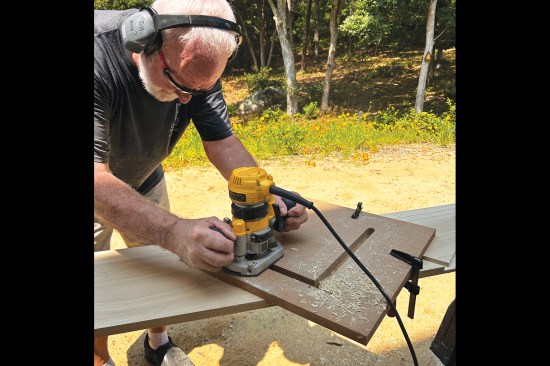 The author used a router template and a top-bearing straight bit to cut 3/8-inch-deep recesses into the skirtboards.
