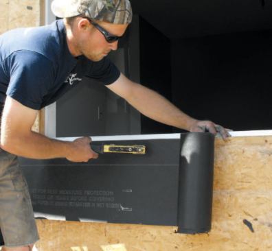 Using heavy, asphalt-saturated kraft papers with high enough permeance to meet code, I start with the sills, running a 16-inch-wide strip of 60-minute paper flush with the rough opening and 8 inches past both jambs.