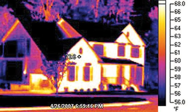 Daylong exposure to sunlight has loaded the south-facing wall of this home with stored heat. In the image, taken soon after dark, the roofing has radiated most of its heat to the night sky.