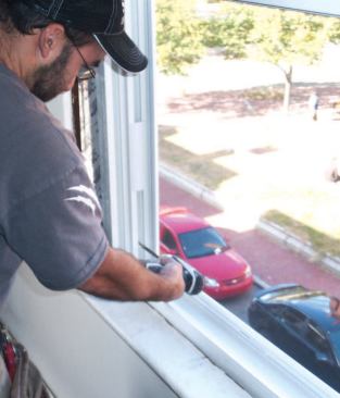 Because I've already set the shim screws, I know that the window is level along the bottom. Next I plumb one side, then the other, starting with the bottom installation screw.