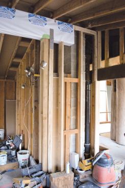 We used a pair of jacks to push the beam up tight against the rafters.