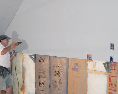The author installs the upper course first, locating the brackets about 48 3/8 inches below the ceiling.