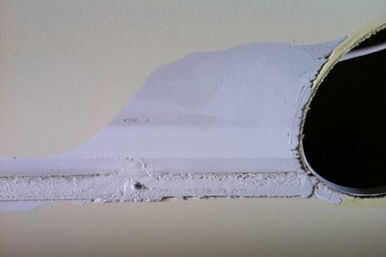 Tape removed, paper veneer tear and exposed fastener. This is how it looks when dry.