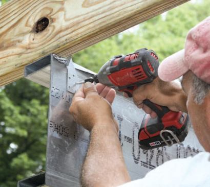 Where joists cross the LiteSteel beam, self-tapping metal screws secure the metal ties. Note the strip of flashing membrane separating the pressure-treated lumber from the steel.