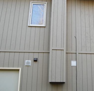 In this installation the exhaust and intake are high in the wall and separated 6 feet horizontally to meet code. The intake louvers are permanently open, but the exhaust louvers open only when the HRV is running.