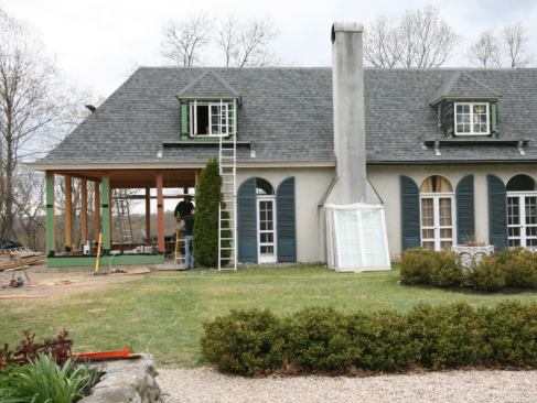 With the trim in place and the dormers framed up, we reroofed the whole building. That involved stripping the rest of the existing roofing from the main house, applying white, factory-painted drip edge at the perimeter, and covering any remaining exposed areas of sheathing with Tri-Flex underlayment. We used Owens Corning Duration architectural shingles, and because the site is fairly windy and the roof pitches are steep, we used the double-nailing pattern recommended for high-wind areas (see “Roofing With Asphalt Shingles,” May/14).
