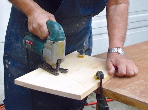 Make the Wood Router Template: I smooth the lines with the French curve before carefully cutting the pattern out with a saber saw.