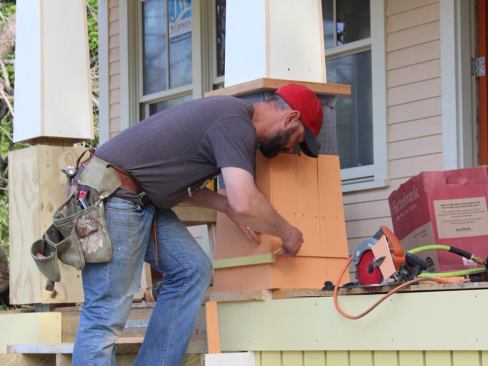 Scribing another corner shingle in place.