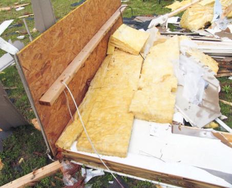 A braced corner in front was pulled off when its connection to the bottom plate failed.