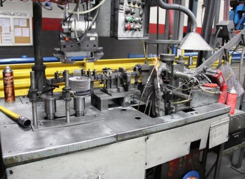 This automated gizmo welds the finished nails to the collating wire. Nails enter from the right, are welded to the wire (look closely and you’ll see the sparks), and then spun into coils (left side of photo). 
Click here for video.