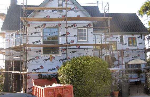 When the installation includes housewrap, the author applies an additional layer of Grade D building paper as the shingles go up.