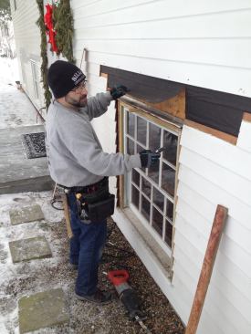 With the clapboards above the window removed, the underlayment needs to be loose so that the new window flashing can tuck underneath it.