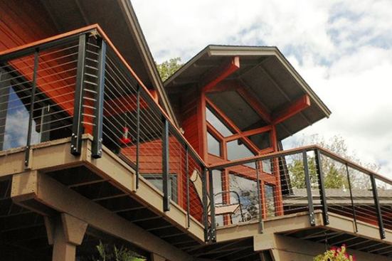 Cables can be made to turn corners without tensioning devices, either by fastening eyes bolt made for this purpose to the inside faces of the post, or by installing double posts at corners (pictured) and threading the cables through holes drilled through the posts. Be aware that corners make tensioning more difficult, so manufacturers recommend no more than one or two un-tensioned corners per run of cable.