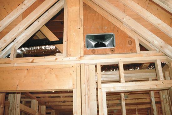 Here, a forced-air register is installed in a piece of 3/4-inch plywood where it penetrates the attic air barrier. The register boot is caulked to the plywood.