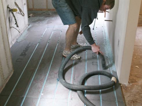 After the PEX pipes are installed, the channels are filled with thinset.