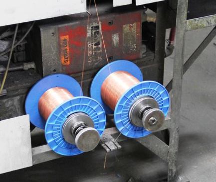 These spools of wire feed to the automated gizmo that welds them to the incoming nails.