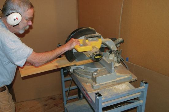 With the end of the board against the chop saw fence plunge the blade all the way down.