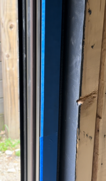 After the shims are cut back, the window is protected by painter’s tape ... 