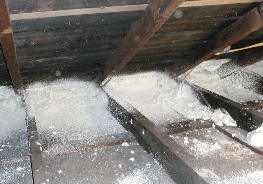 To seal leaks at the eaves and provide added R-value in an area where insulation depth was limited, a thicker buildup of two-component foam was applied at the intersection of rafters and top plates.