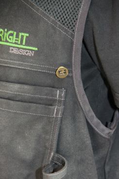 On my vest there is a large rivet just above the left chest pocket. It resembles the rivets used to secure straps on farmer-style overalls – and serves a similar purpose…