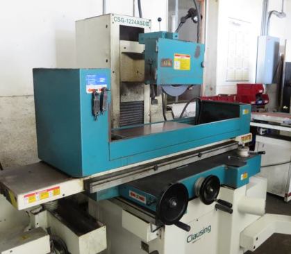 This surface grinding machine is used to grind plane blades. The table moves back and forth under the spinning head, which can be set up to flatten or bevel blades. After the machine work is done the blade will be honed by hand.