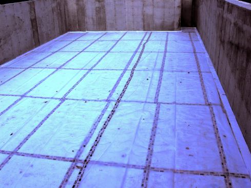 Sub-slab insulating foam and a poly vapor barrier in place before the slab is poured.