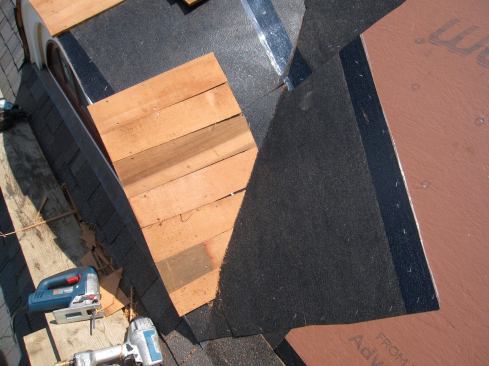 Ryan ran red-cedar shingles as a starter course on the dormer. Asphalt shingles were then woven across the valleys.