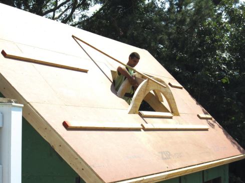 The ribs were spaced 10 1/2 inches on-center with 2x6 blocks cut at a plumb angle for a 4/12 pitch. A furring strip tacked to the roof and to the first rib held the first rib in position while the other ribs were being installed.