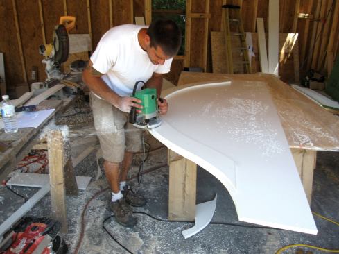 The window trim was cut from 3/4-inch PVC. Ryan started with the wider piece of fascia trim, and used it as a guide to cut the curve on the second piece of trim.