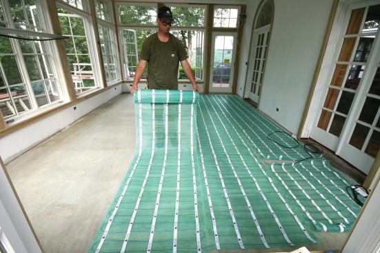 Electric radiant mats were rolled out according to the manufacturer's installation diagram. The longest mat needed to be carefully cut (without cutting the wire) in three places to make 180-degree turns.