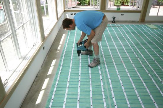 Tapcon screws drilled roughly 48 inches on-center served as benchmarks for the finish elevation of the underlayment.