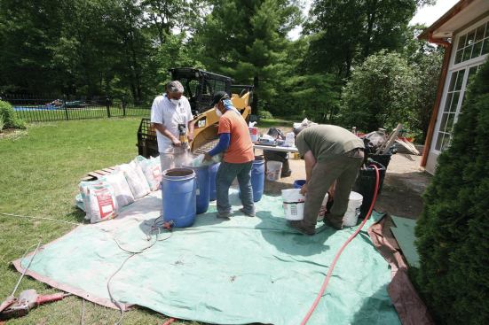 The underlayment was mixed outside. The crew used a high-speed mixer and an egg-beater paddle to mix it to the right consistency.