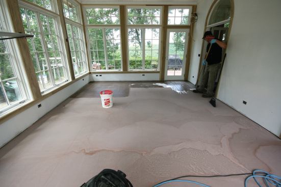 After the underlayment cured overnight, a latex primer was rolled on. This would help the crack-isolation membrane bond to the underlayment.