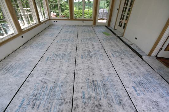 The crew cut and laid out the crack-isolation membrane before installing it.