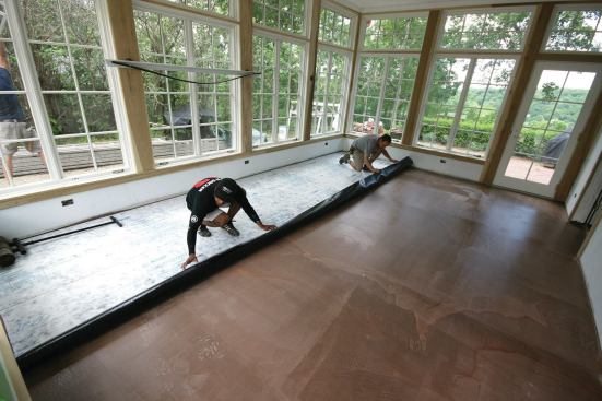 It took two guys to lay out the membrane, release the backing, and ...