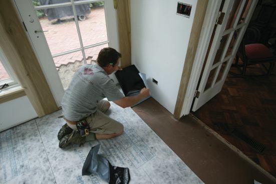 The crack-isolation membrane was pieced in around the door opening. 