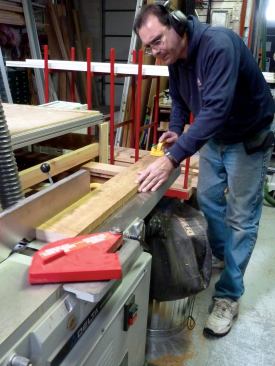 First, one face of the board is flattened. With one edge riding against the jointer fence, the board is fed face down across the jointer blade.