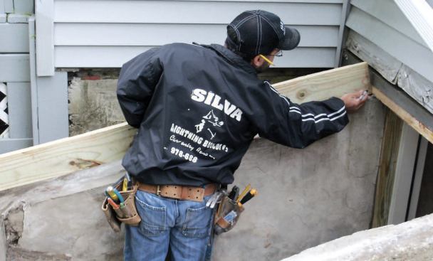 Sides: To avoid having to remove more than one course of the house's vinyl siding, I kept the wood base as low as possible at the top, marking the height on a treated 2x6.