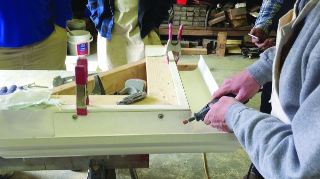 To execute a clean patch, Moore roughed up the gutter’s hardened, gel-coat surface to promote bonding between the gutter and the fiberglass patch.