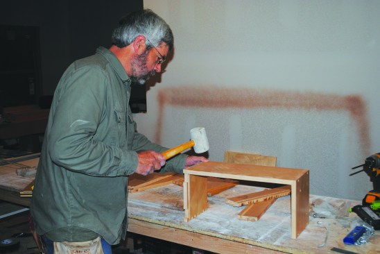 Dovetailed cabinet drawers also have to be assembled. The author taps and tacks the front, back, and one side together.