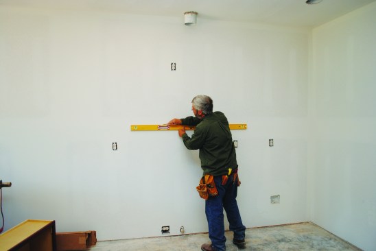The author draws a level line on the wall at the proper height.