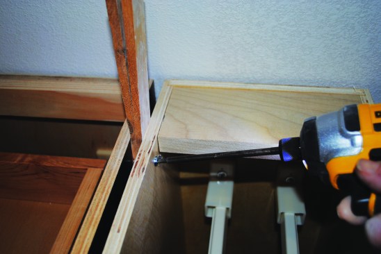 As with the wall cabinets, the face frames are lined up and screwed together. Shims and screws keep adjacent cabinets spaced properly and hold them together at the back.