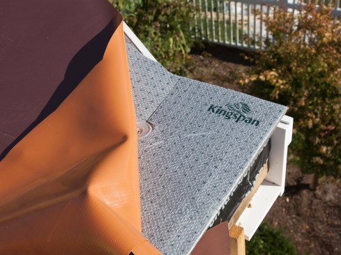On this re-roof project, two different rigid foam underlayment products were used. Here, a 1/2-inch-thick polystyrene protection-board was installed. The author avoids using fiberboard underlayment because unlike fiberboard, the polystyrene underlayment doesn’t absorb water, ensuring a dry base in the event that the underlayment is left temporarily exposed during installation — once fiberboard gets wet, it tends to stay wet and can even promote rotten plywood decking.